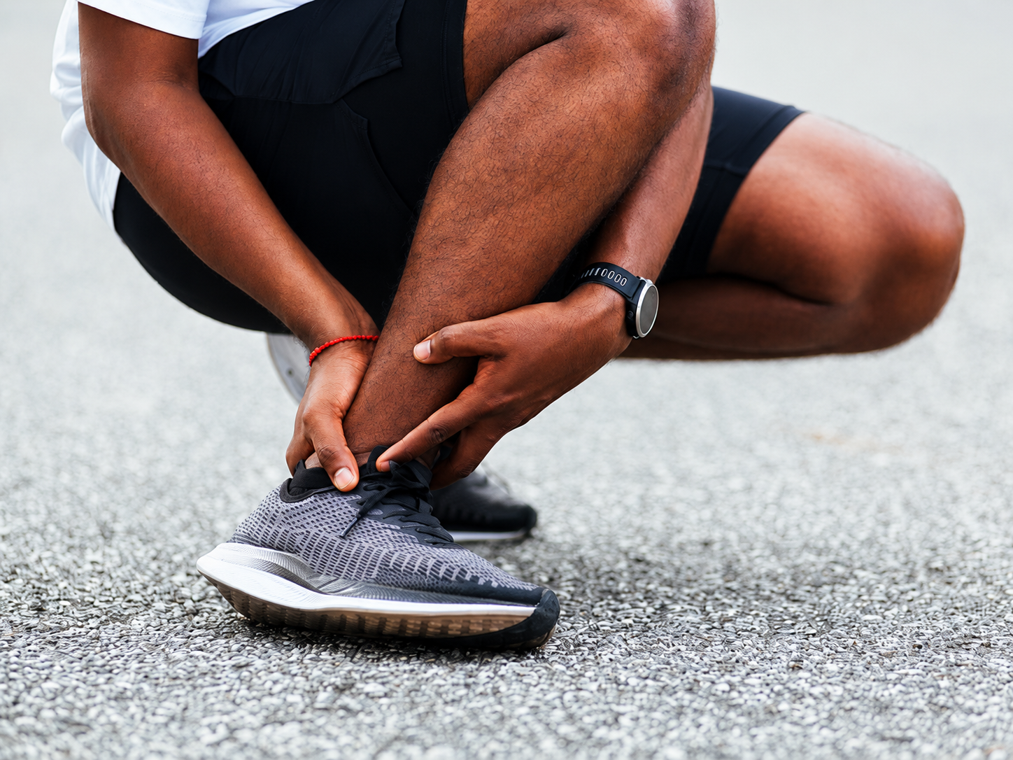 Runner holding a lower leg sports injury
